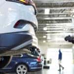VW Certified Collision Repair mechanic inspecting a car