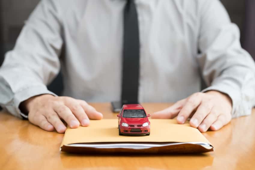 MINI financing paperwork with toy car on top