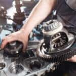 Cross-section of a car gearbox. mechanics work in the garage. hand car mechanic in working clothes.