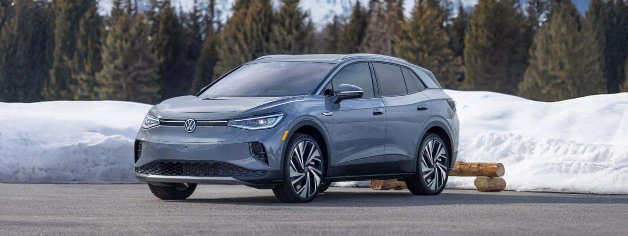 Gray 2026 Volkswagen ID.4 parked in front of snowy forest