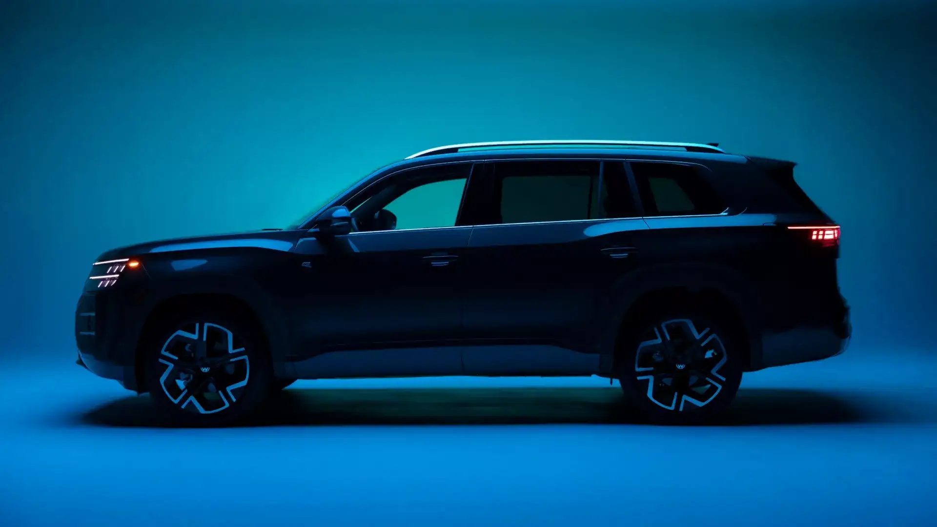 Navy Blue 2027 Volkswagen Atlas parked on dimly lit blue background