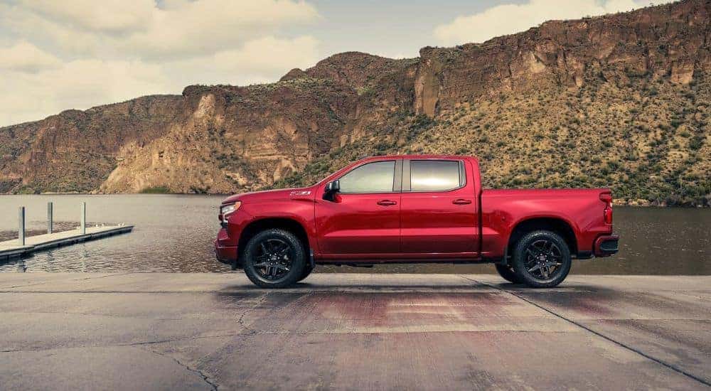 A red 2024 Chevy Silverado 1500 Z71 near a lake.