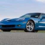 A blue 2011 Chevy Corvette Grand Sport is shown parked on pavement.