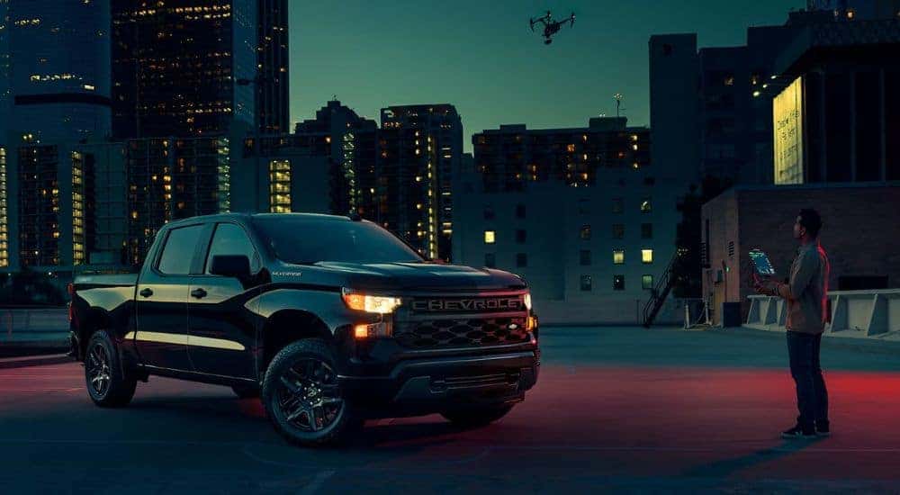 A black 2024 Chevy Silverado 1500 at night.