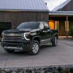 A black 2024 Chevy Silverado 2500 for sale parked on a driveway.
