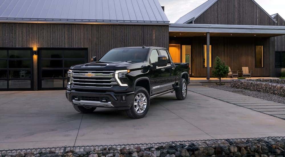 A black 2024 Chevy Silverado 2500 for sale parked on a driveway.
