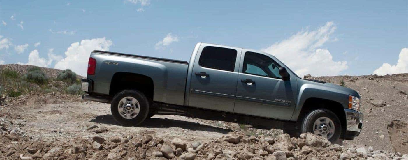 A blue/grey 2012 Chevy Silverado 2500 HD off-roading.