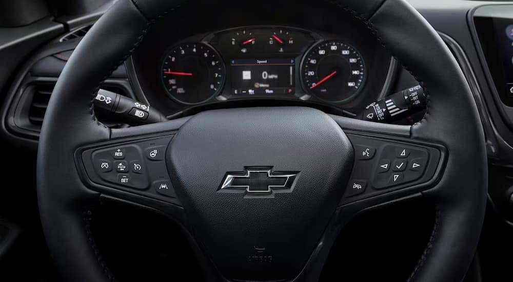 A close up of the steering wheel of a 2024 Chevy Equinox RS.
