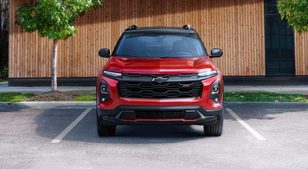 A red 2025 Chevy Equinox RS for sale is parked in a lot.