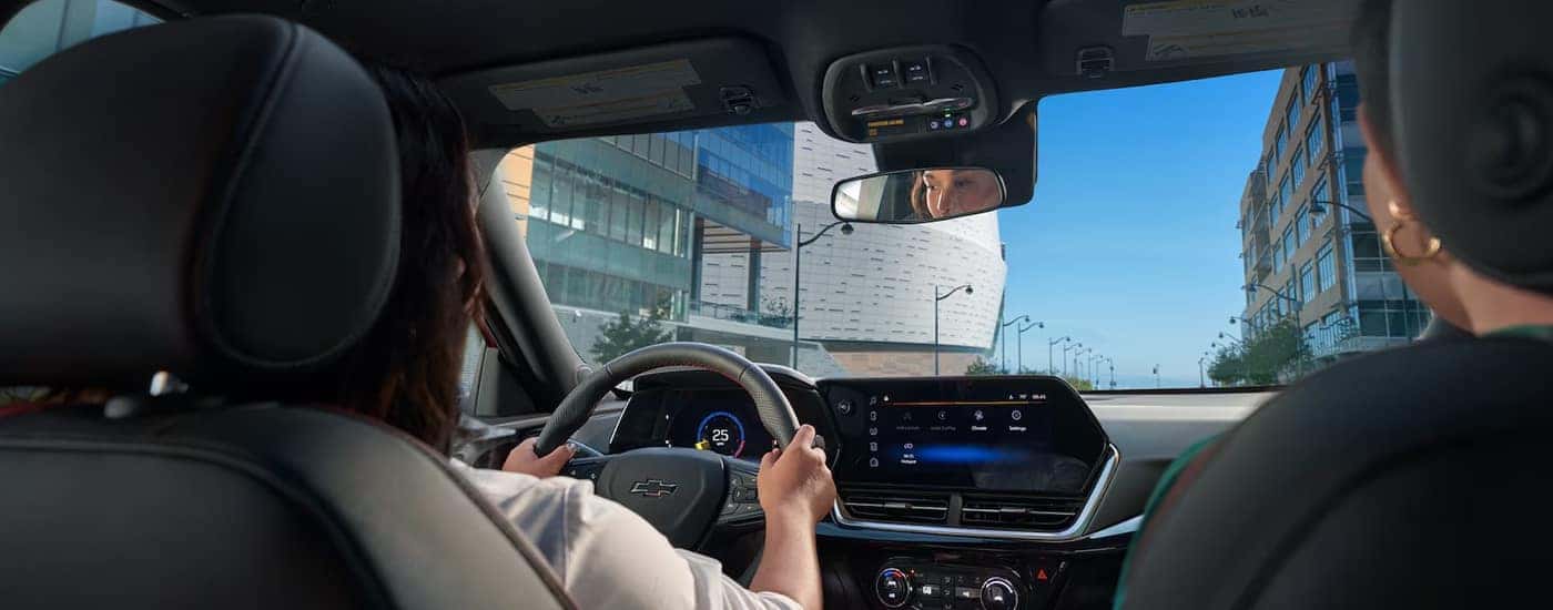Two women driving in a 2025 Chevy Trax for sale. 