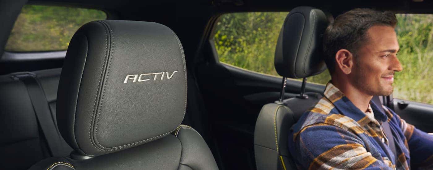 A man is driving in a 2025 Chevy Trailblazer ACTIV.