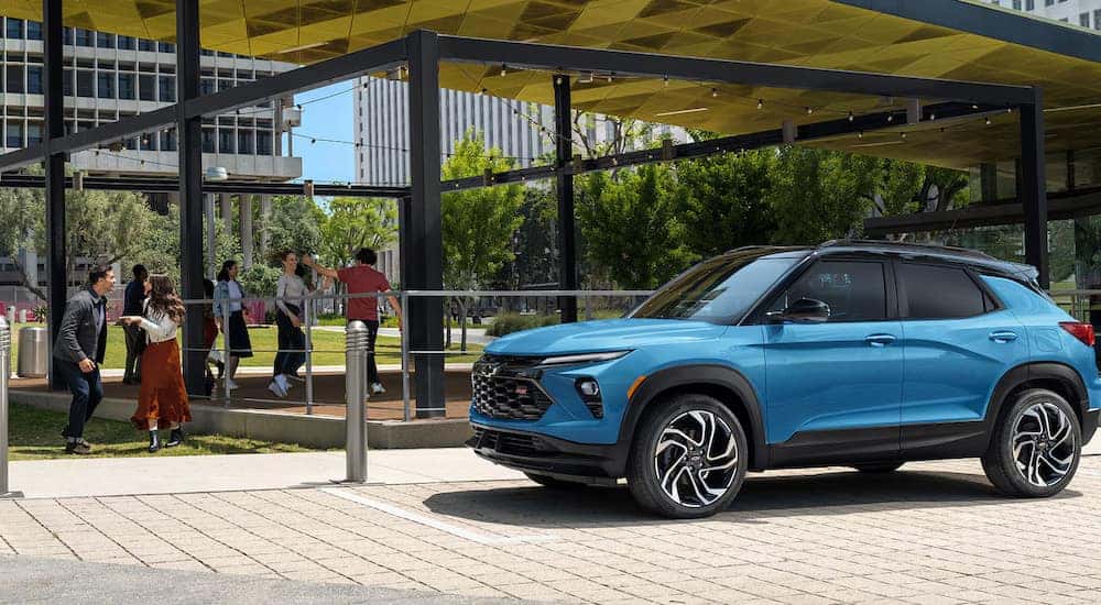 A blue 2025 Chevy Trailblazer RS parked at an outdoor cafe.