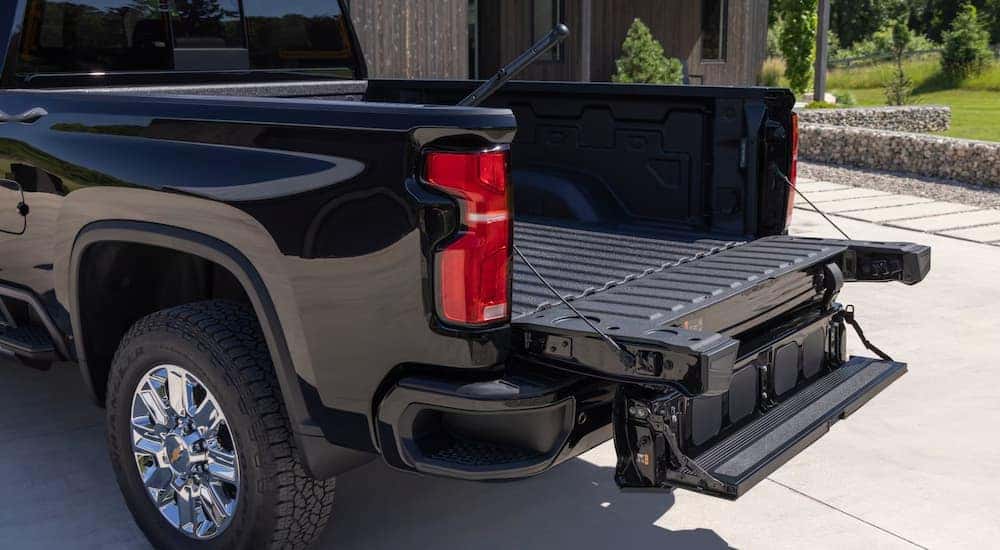 Open bed of a black 2025 Chevy Silverado 2500HD at a Chevy dealer near Roebuck.