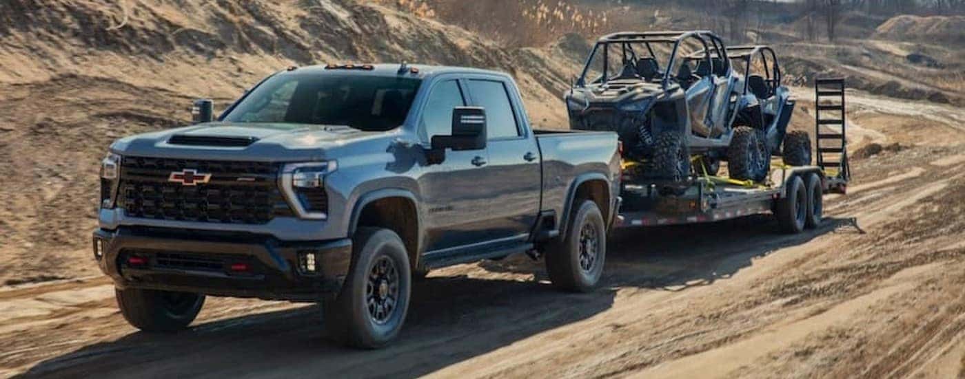 A gray 2025 Chevy Silverado 2500 ZR2 towing a trailer.