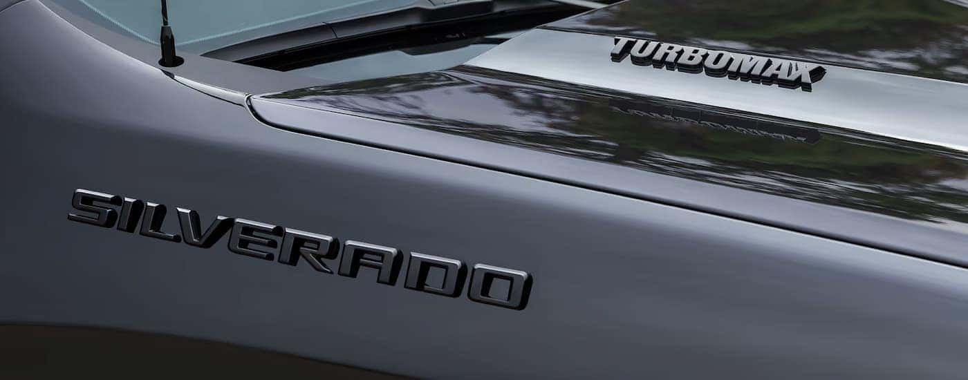 A closeup of the badge on a black 2025 Chevy Silverado 1500 Turbomax Blackout for sale near Duncan.