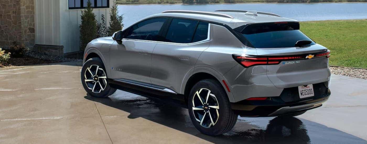A silver 2024 Chevy Equinox EV parked on a driveway.