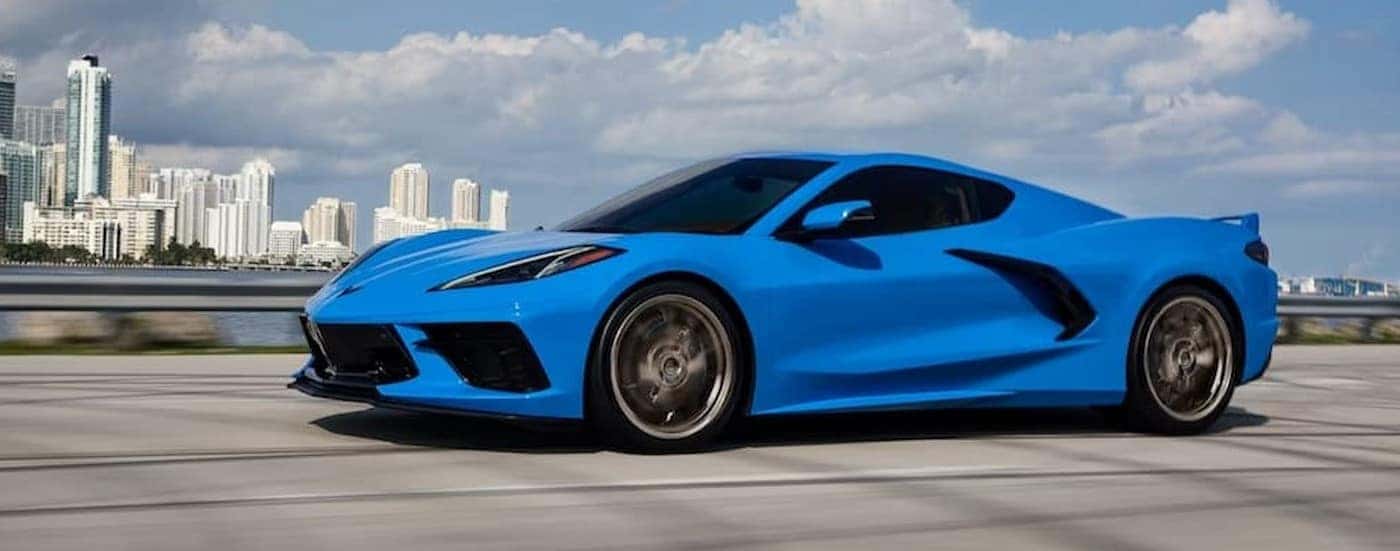 A blue 2024 Chevy Corvette Stingray driving after visiting a used Chevy dealer near Boiling Springs.