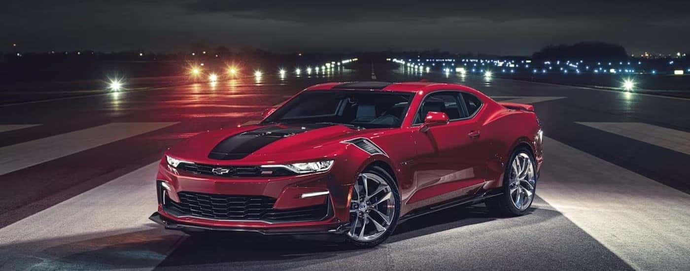 A red 2024 Chevy Camaro parked at night after visiting a used Chevy dealer near me.