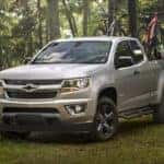 A silver 2019 Chevy Colorado parked off-road after leaving a used car dealer.