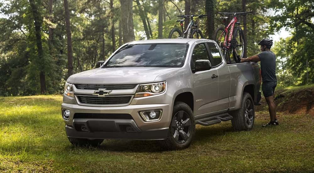 A silver 2019 Chevy Colorado parked off-road after leaving a used car dealer.