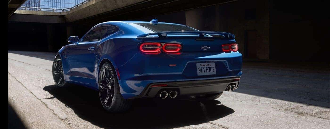 Rear of a blue 2023 Chevy Camaro SS driving through a tunnel.