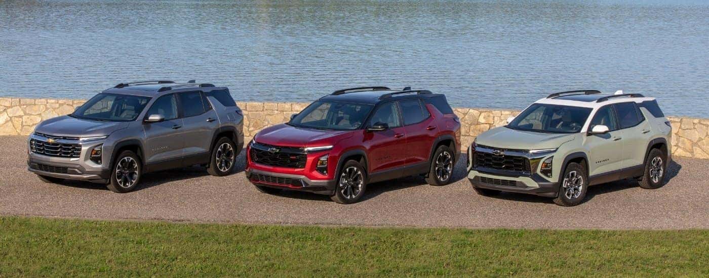 A grey, red, and green 2025 Chevy Equinox from the front.