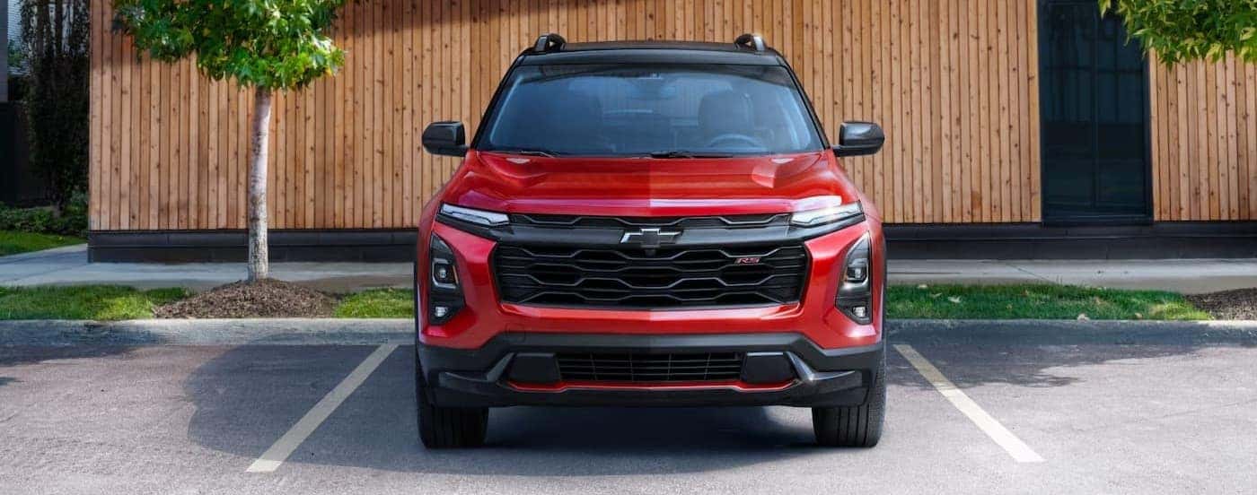 A red 2025 Chevy Equinox RS parked near a Chevy dealer near Gaffney.