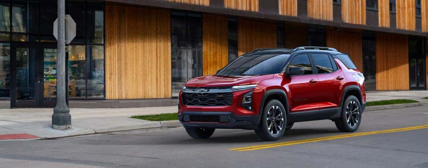 A red 2025 Chevy Equinox RS parked at an intersection