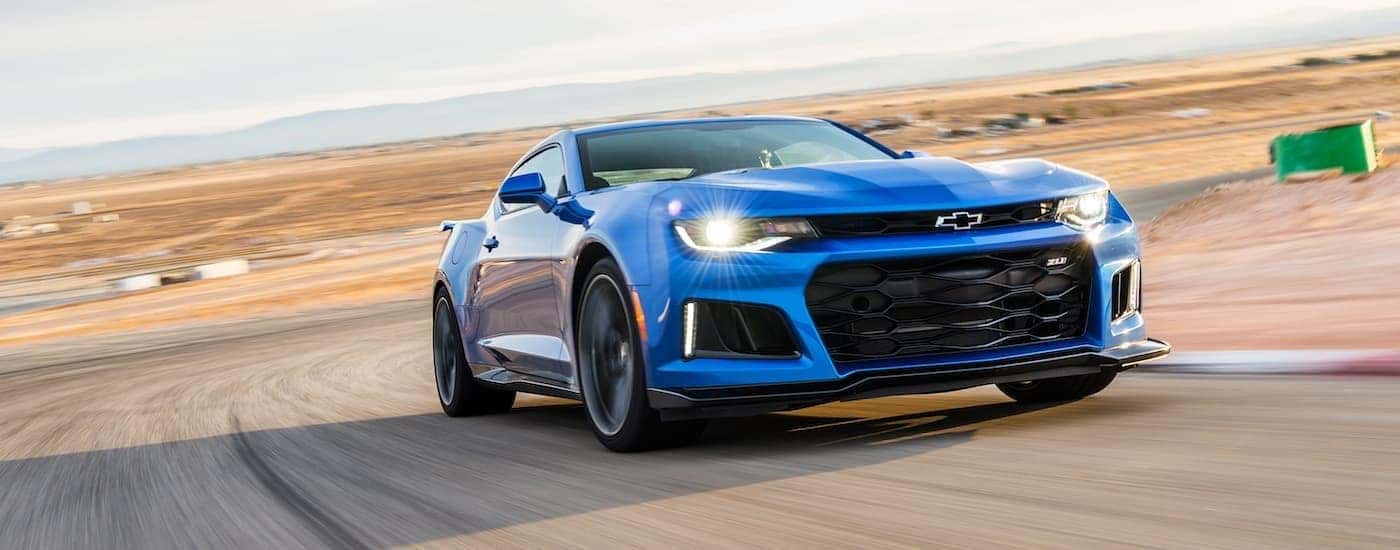 Blue 2017 Chevy Camero ZL1 driving around a track. 