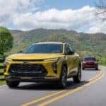 Two 2025 Chevy Trax driving to look at used Chevys for sale