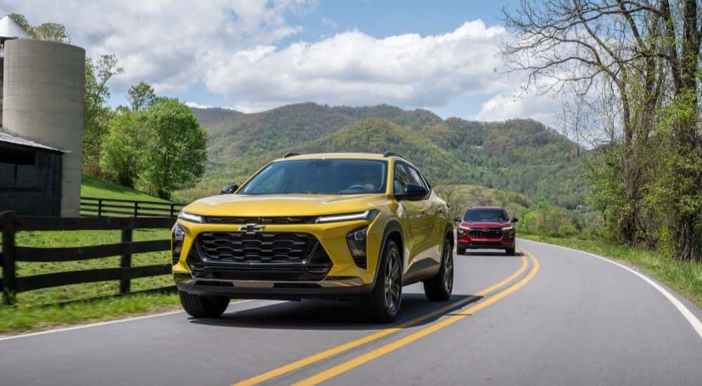 Two 2025 Chevy Trax driving to look at used Chevys for sale