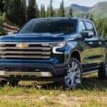 A blue 2023 Chevy Silverado 1500 parked on grass.