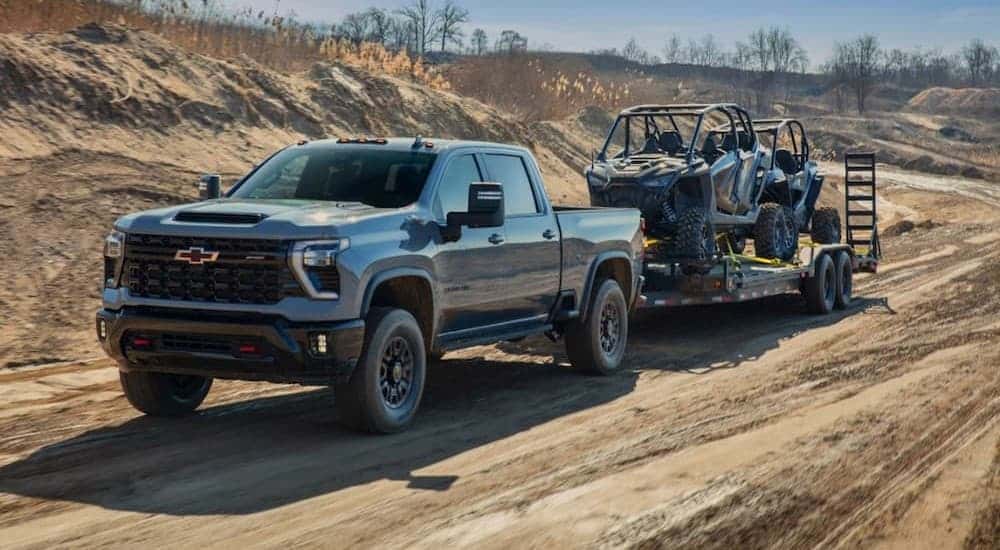 A gray 2024 Chevy Silverado 2500 ZR2 towing a trailer.