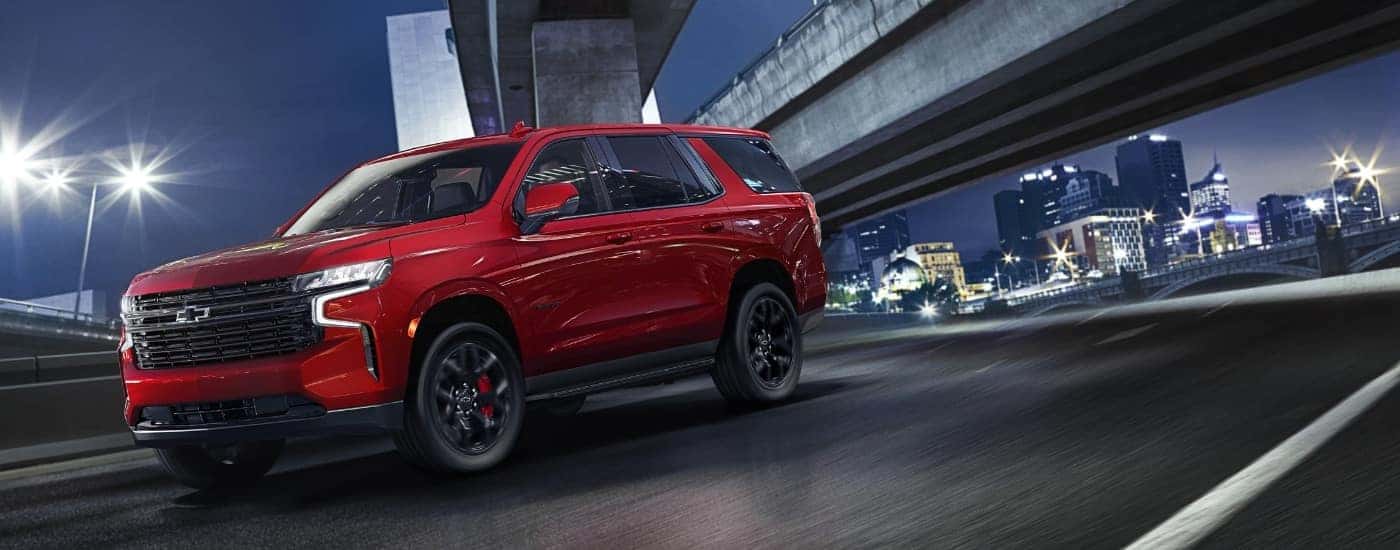 A red 2023 Chevy Tahoe from the front after leaving a dealer that has a used Chevy for sale near Wellford.