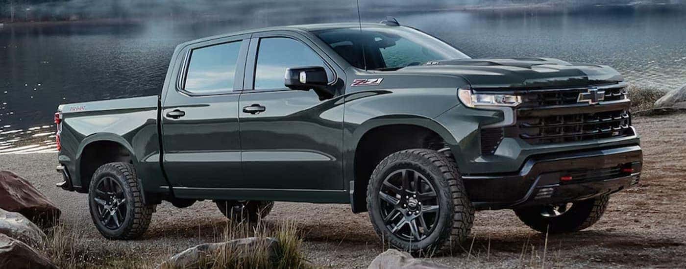 A green 2026 Chevy Silverado 1500 Z71 parked near water.