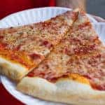 slices of cheese pizza on paper plate