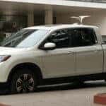 a white honda ridgeline on the street