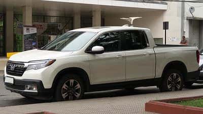a white honda ridgeline on the street