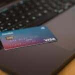 a visa card on a laptop keyboard