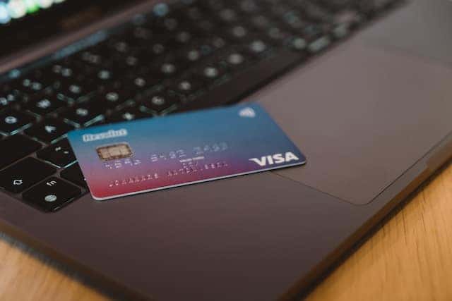 a visa card on a laptop keyboard