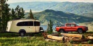 toyota tacoma towing a camper in the mountains
