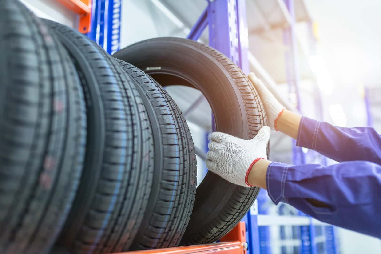 Technician rotating car tires