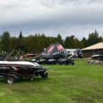 boats and ATVs on display in a field in eganville