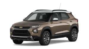 A brown and white 2021 Chevy Trailblazer is facing left.