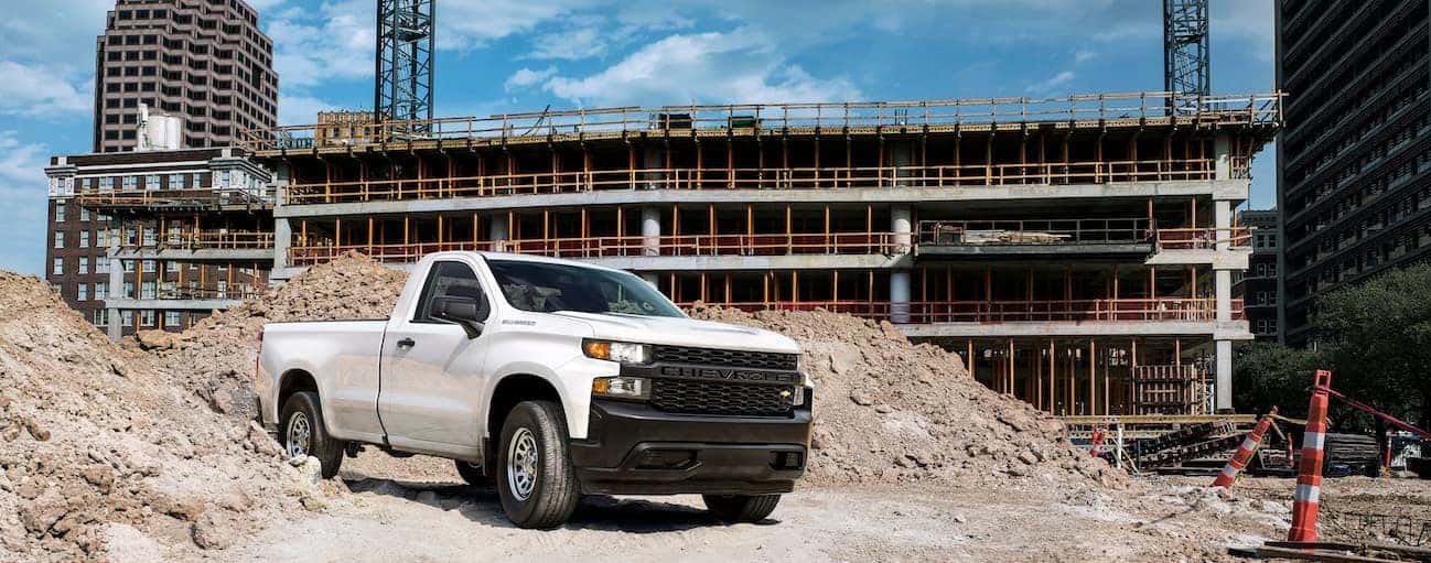 A white 2019 Chevy Silverado is parked at a worksite.