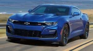 A blue 2020 Chevy Camaro is facing left.