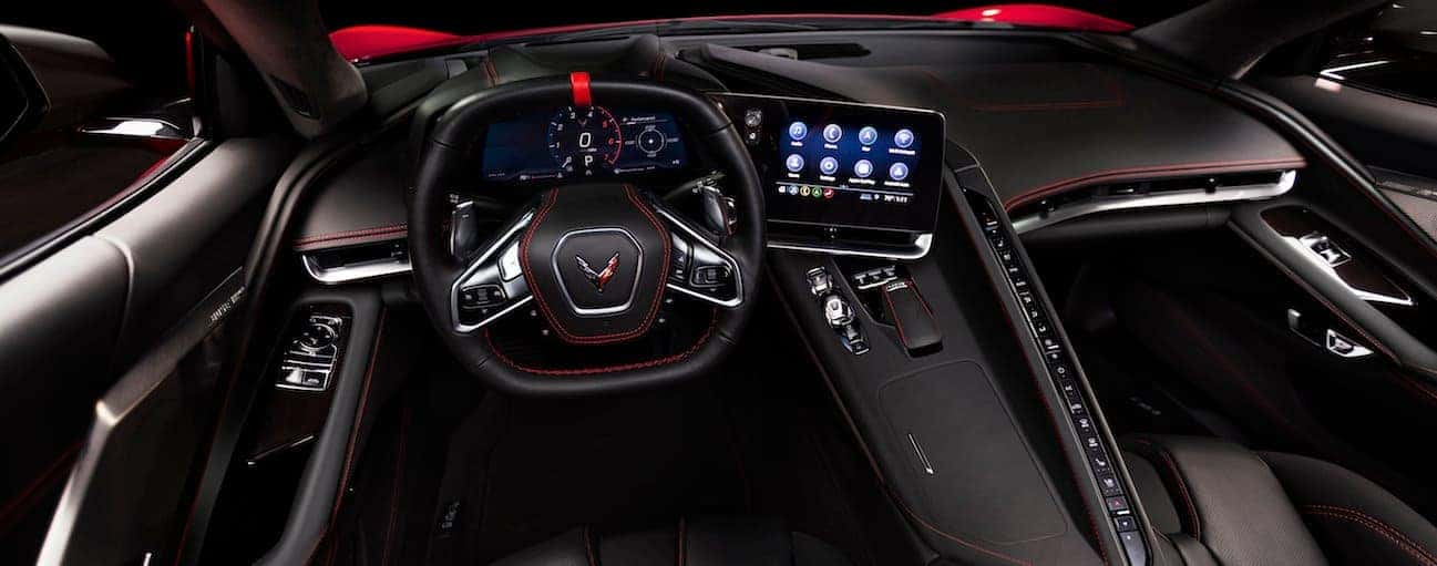 The front black leather interior of the 2020 Chevy Corvette is shown.