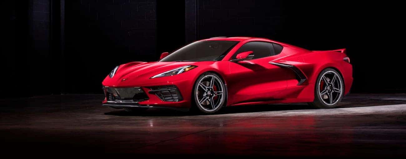 A red 2020 Chevy Corvette, which wins when comparing the 2020 Chevy Corvette vs 2019 Chevy Corvette, is parked in a dark parking lot near Bethlehem, PA.