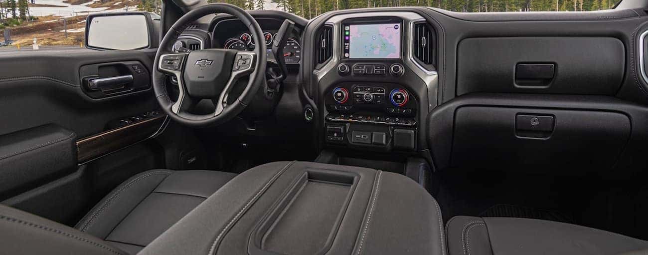 The front black leather interior of a 2020 Chevy Silverado 1500 is shown.
