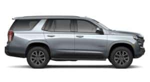 A silver 2021 Chevy Tahoe is shown from the side.